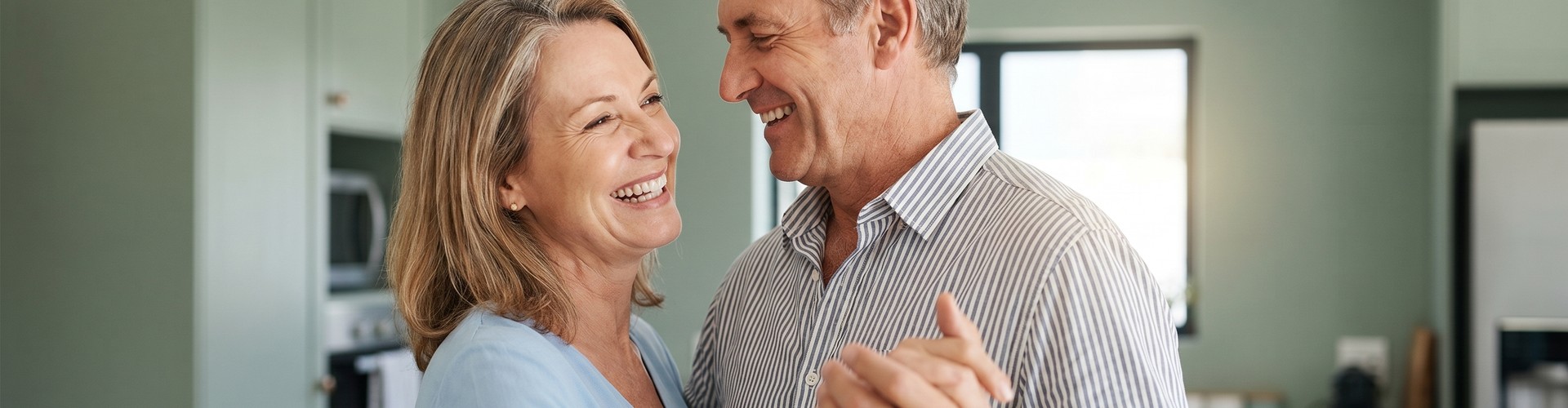 Mature couple smiling at each other.